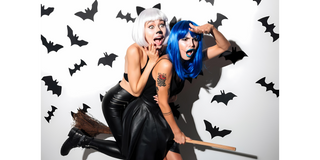Girls dressed up for halloween on broomstick
