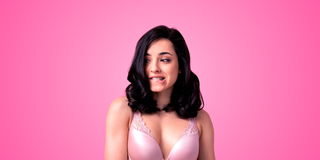 Woman wearing pink bra biting her lips 