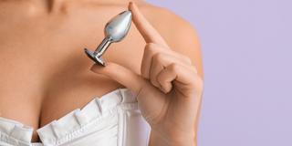 Woman holding anal plug
