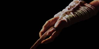 Hands tied together with Japanese shibari bondage rope 
