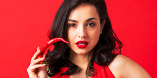 Woman holding red chili pepper 