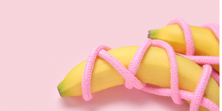 Two bananas tied in pink rope 